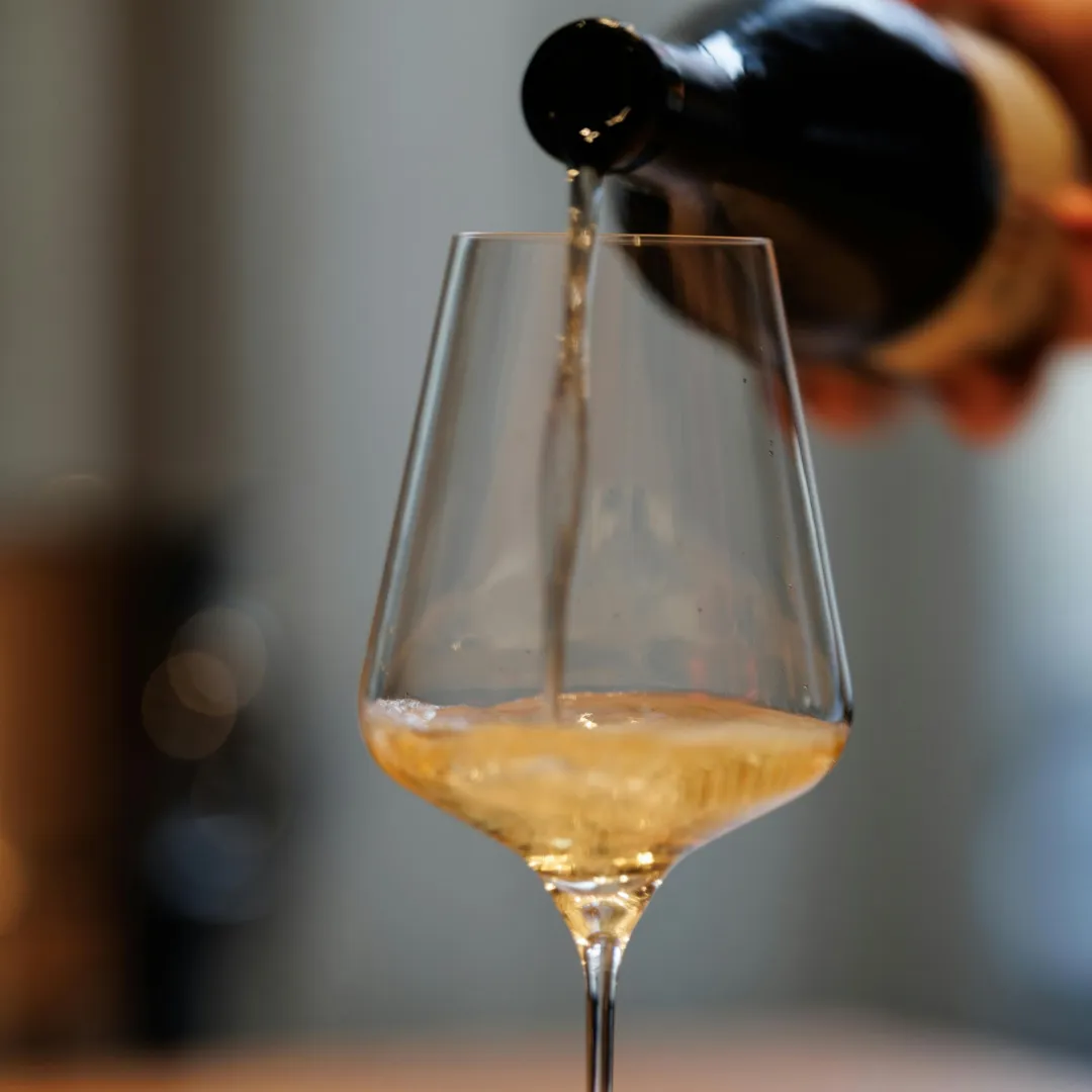 White wine being poured into a glass