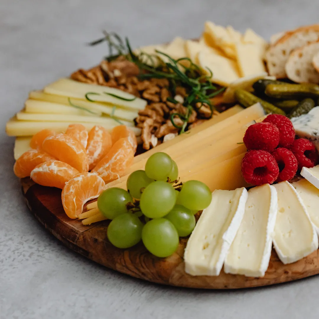 Cheese board with fruit, nuts and bread